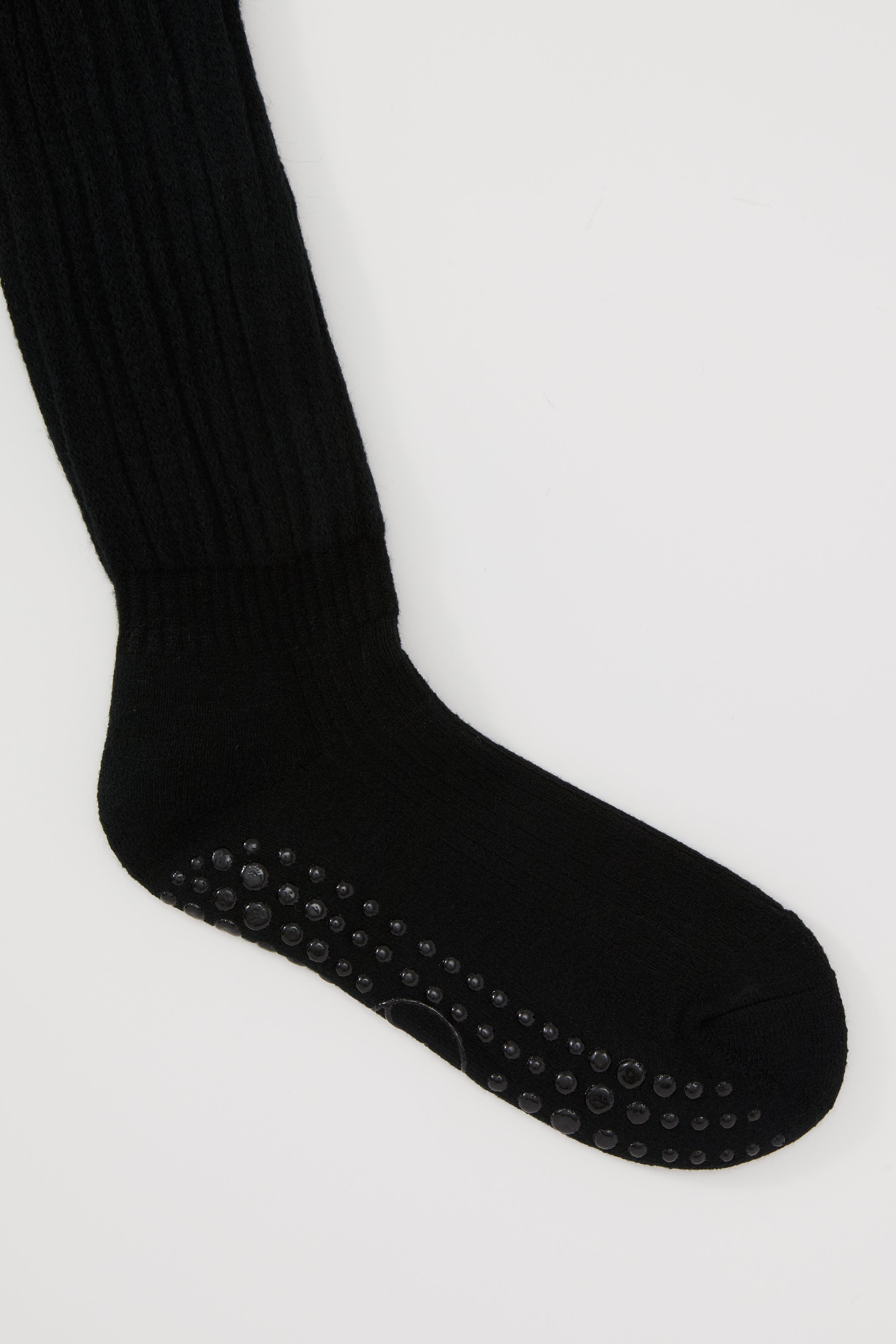 The Studio Grip Warmer in Onyx, ankle and grip sole detail