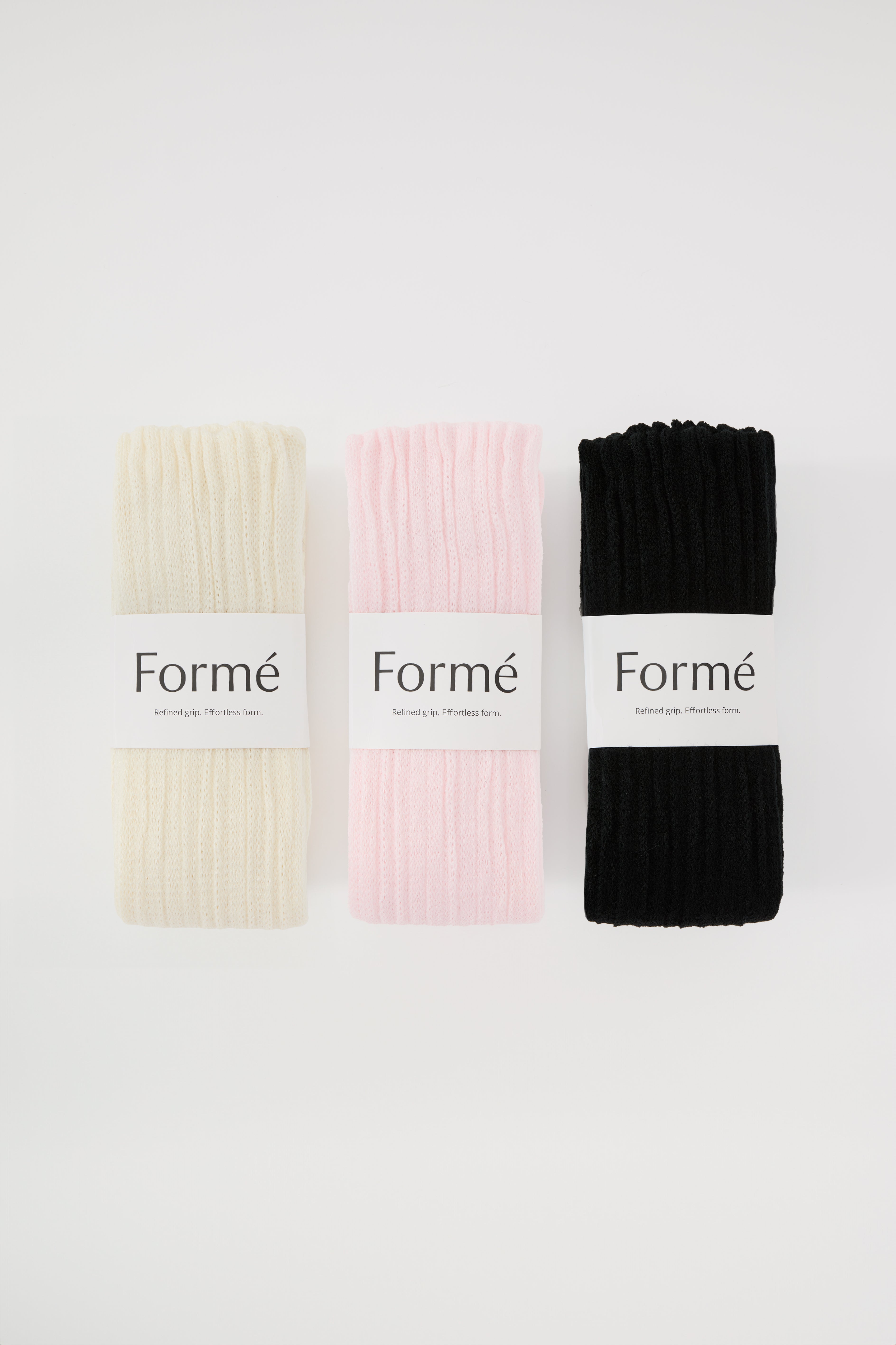 The Complete Set, three pairs in Ivory, Blush, and Onyx folded with Formé bands