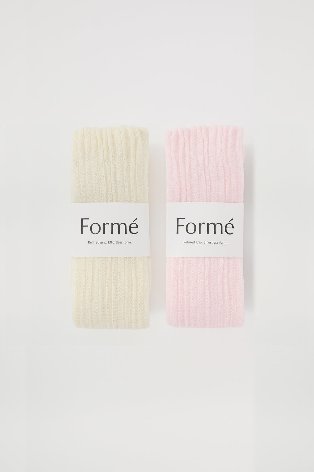 The Duo Set: two pairs of the Formé Studio Grip Warmer in Ivory and Blush, packaged flat-lay