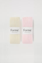 The Duo Set: two pairs of the Formé Studio Grip Warmer in Ivory and Blush, packaged flat-lay