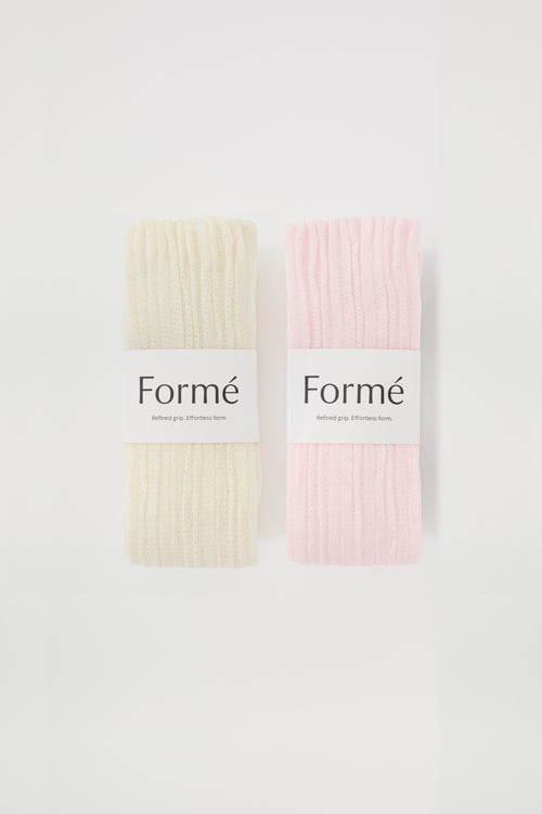 The Duo Set: two pairs of the Formé Studio Grip Warmer in Ivory and Blush, packaged flat-lay