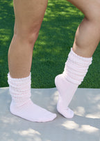 Model wearing the Studio Grip Warmer in Blush, standing, side view